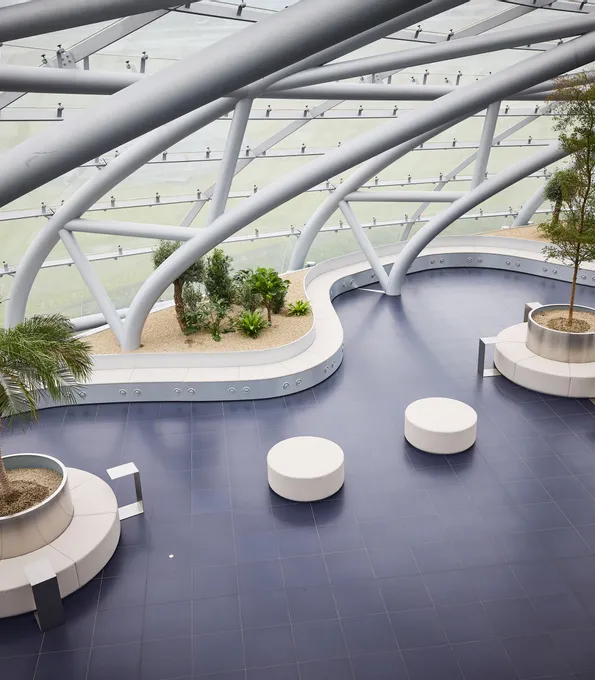 Interior view of Hangar-7 showing its glass-and-steel architecture, seating arrangements and plants