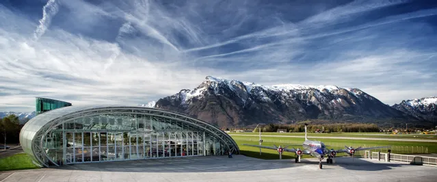 Outside shot of Hangar-7 with the Douglas DC-6 on the airfield and the Untersberg in the background
