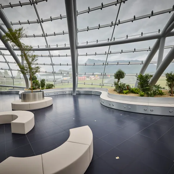 Interior view of Hangar-7 showing its glass-and-steel architecture, seating arrangements and plants