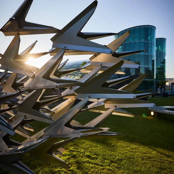 Metal sculpture in front of the glass architecture of Hangar-7